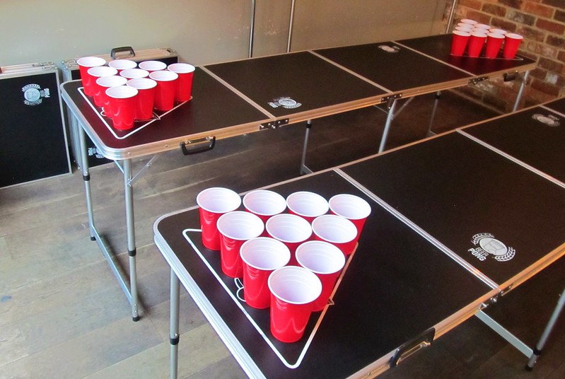Two portable beer pong tables set up with red cups